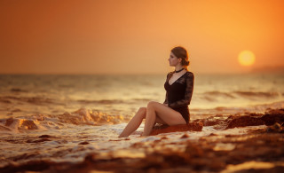 Woman rock ocean sunset sitting - cinematic photography free wallpaper