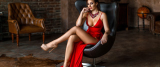 Red dress sitting elegant portrait 2 - a brick wall in the background free wallpaper