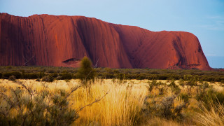 Giant rock formation desert grass - a large rock formation in the middle of a desert area free wallpaper