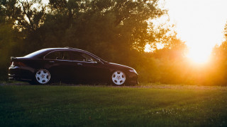 Black car field sunset forest - the sun shining behind free wallpaper