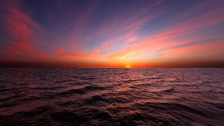 Sunset ocean boat clouds sky 2 - a boat in the distance free wallpaper