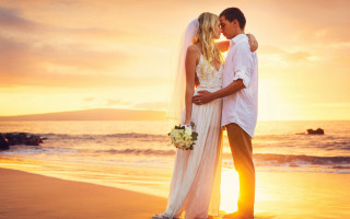 Beach sunset romantic kiss couple - a bride and groom free wallpaper
