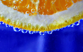 Orange slice water droplets blue - an orange slice free wallpaper