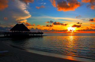 Sunset beach hut water people - the beach in the distance free wallpaper