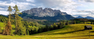 Grassy field house mountains clouds - the top of it free wallpaper
