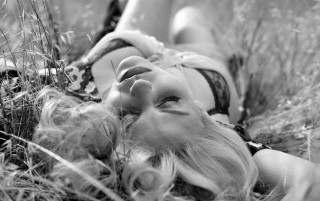 Woman lying grass closed eyes - the side of her body free wallpaper