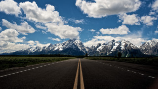 Mountain road clouds sky ocean - a mountain range in the background free wallpaper for desktop