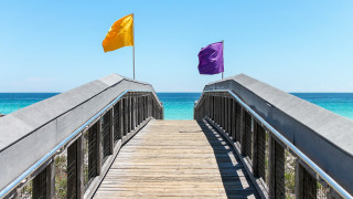 Wooden bridge flags ocean beach - top of it next free wallpaper