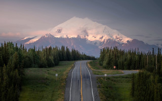 Mountain road forest sunset horizon - a mountain in the background and trees free wallpaper