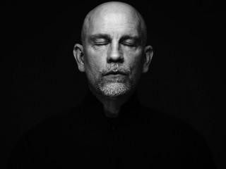 Bald man black shirt portrait - studio portrait free wallpaper