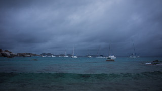 Boats cloudy stormy beach ocean - water under a cloudy sky free wallpaper