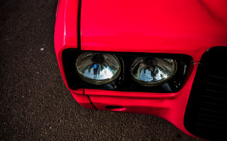 Red car parking lot outrun - a black hood free wallpaper