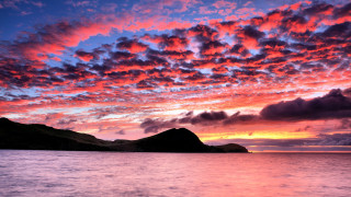 Sunset mountains water boat clouds - a sunset over a body of water free wallpaper