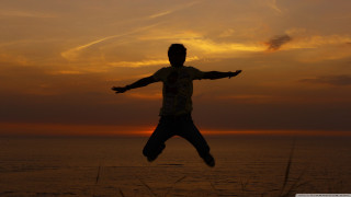 Man jumping sunset arms outstretched - his hands out free wallpaper for desktop