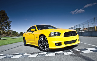 Yellow car checkered road blue - a green grass area free wallpaper
