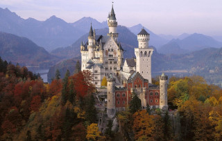 Castle tower forest lake mountains - a lake in the foreground free wallpaper