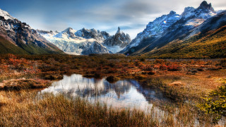 Mountain lake grass trees cloudy - a grassy field in the foreground free wallpaper