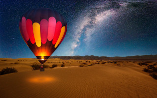 Hot air balloon desert starry - sky in the background free wallpaper