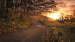 Sunset road fence trees mountains - rich moody colours free wallpaper