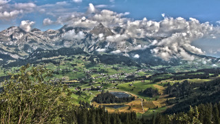 Mountain lake town clouds cityscape - a scenic view of a mountain range free wallpaper