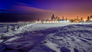 Snowy beach city skyline night - free city wallpaper