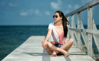 Woman pier sitting blurry beach - a pier free wallpaper for desktop