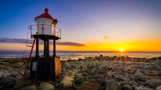Lighthouse rocky beach sunset ocean - free summer wallpaper