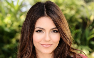 Woman smiling longhair pinkshirt greenbackground - perfect facial symmetry free wallpaper