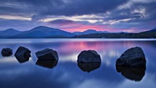 Rocky lake mountains cloudy sunset - top of a lake under a cloudy sky free wallpaper