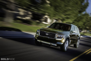 Green suv driving street lush - path free wallpaper