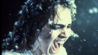 Woman snow falling hair blowing - open free wallpaper