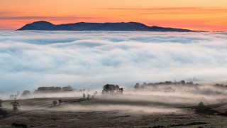 Mountain fog people trees sunset - a hill in the distance free wallpaper