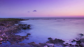 Rocky shore purple sky water - rich moody colour free wallpaper