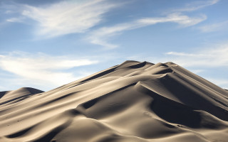 Large sand dune cloudy sky - a large sand dune free wallpaper