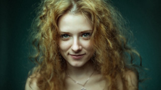 Woman red hair smiling green - a green background behind her free wallpaper