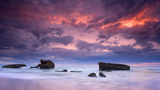 Beach rocks water sunset purple - sky above free wallpaper