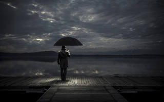 Man dock umbrella lake night - gloomy atmosphere free wallpaper