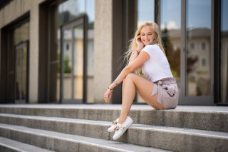 Woman smiling on steps cellphone - caro niederer free wallpaper