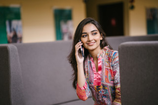 Woman sitting couch talking phone - a laptop computer free wallpaper