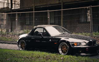 Black car road building fence - the side of a road next free wallpaper