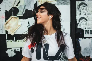 Ella guru woman earbuds posters - promotional image free wallpaper