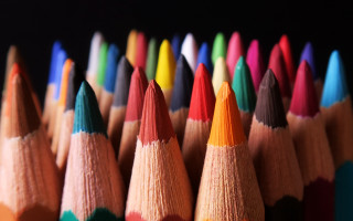 Colored pencils glow depth of - a black background in the background free wallpaper