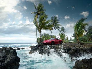 Red sports car rocky shore - a red sports car free wallpaper
