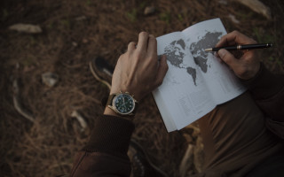 Person holding pen book writing - a world map free wallpaper