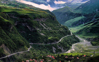 Scenic valley winding road mountains 2 - a scenic view of a valley free wallpaper