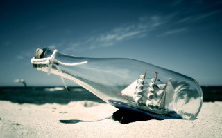 Ship in bottle beach sky 4 - a surrealist sculpture free wallpaper