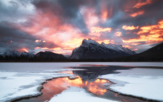 Mountain lake ice sunset clouds - the foreground and a sunset in the background free wallpaper