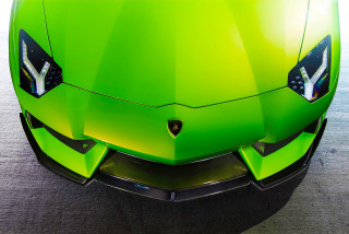 Green sports car black emblem - a green sports car free wallpaper