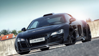 Black sports car driving street - a fence and a fenced in area free wallpaper