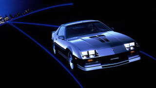 Retrocar citylights synthwave rendering vroom - side and a city in the background free wallpaper